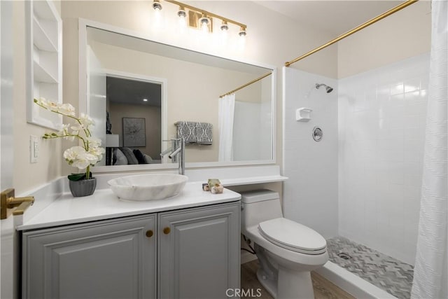 bathroom with vanity, curtained shower, and toilet