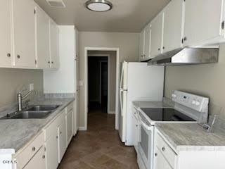 kitchen featuring sink, white appliances, and white cabinets