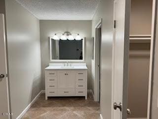 bathroom featuring vanity and a textured ceiling