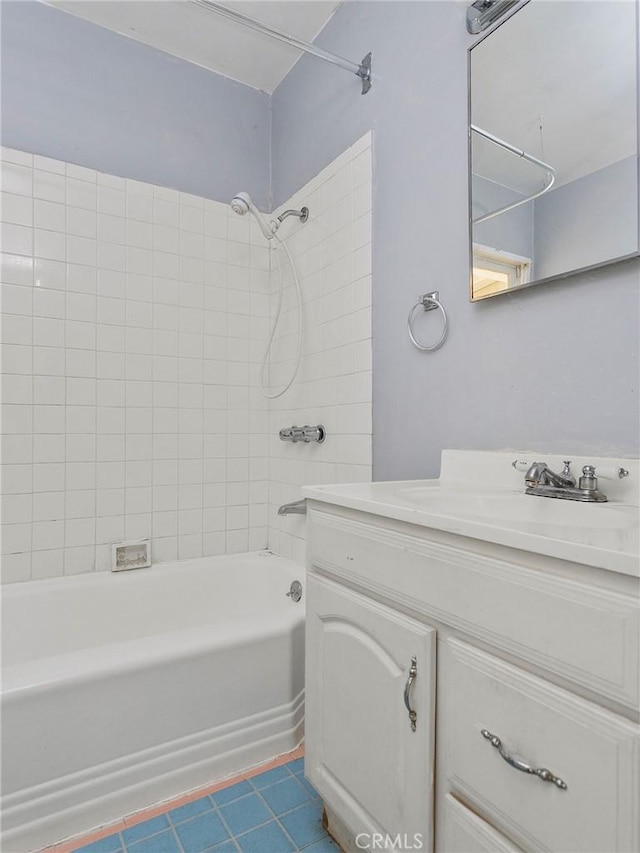 bathroom featuring tiled shower / bath combo, vanity, and tile patterned floors