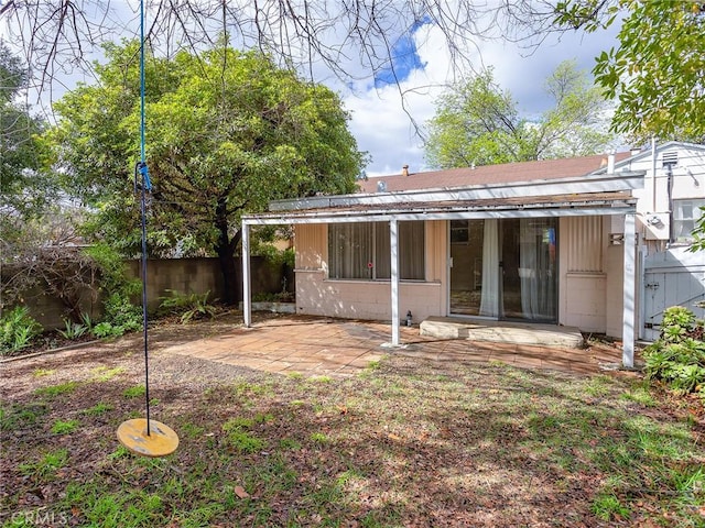 back of property with a patio