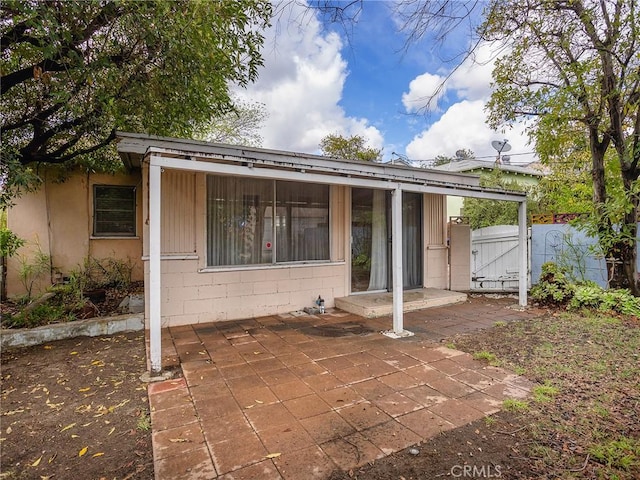 back of house with a patio