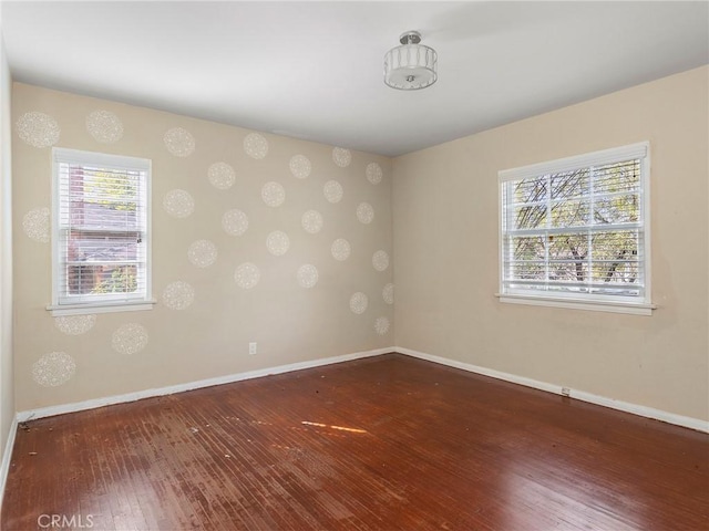 empty room featuring dark hardwood / wood-style flooring