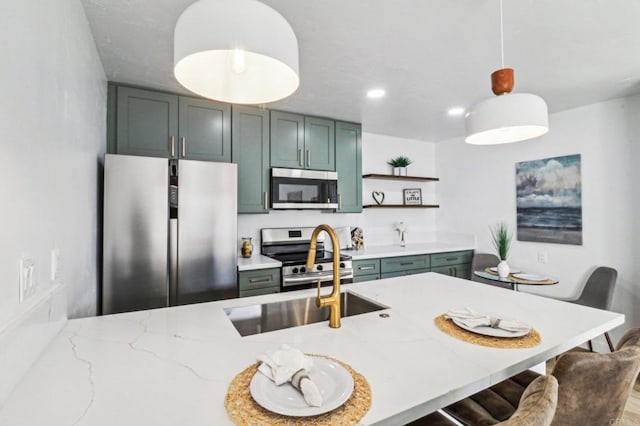 kitchen with pendant lighting, green cabinets, stainless steel appliances, light stone countertops, and a kitchen bar