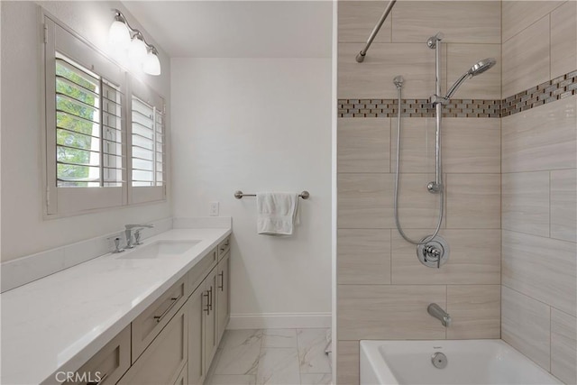 bathroom with bathtub / shower combination, a healthy amount of sunlight, vanity, and marble finish floor