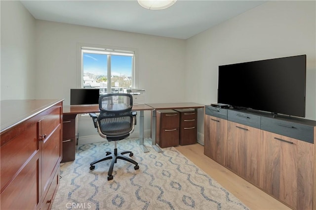 home office with light wood finished floors