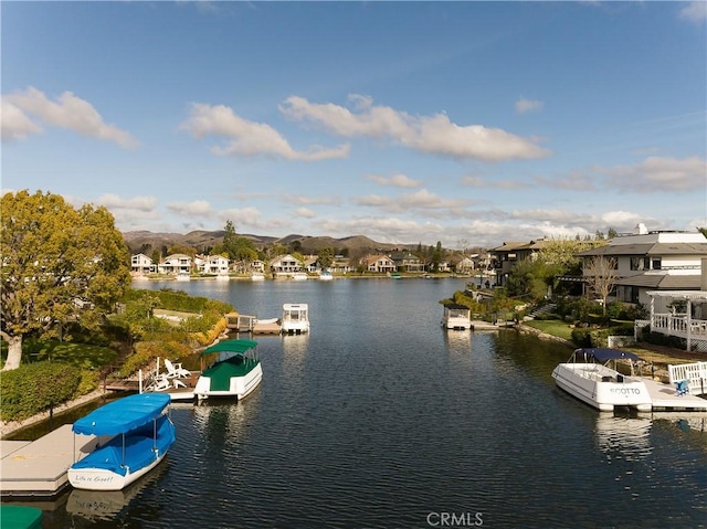 water view with a mountain view and a floating dock