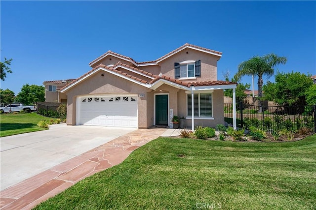 mediterranean / spanish house with a garage and a front yard