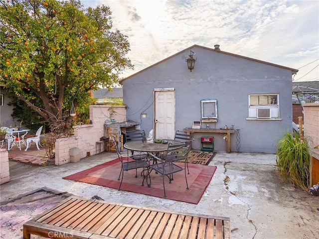 rear view of property featuring cooling unit and a patio