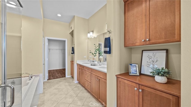 bathroom with vanity, tile patterned flooring, and a bathing tub