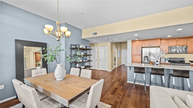 dining space with a notable chandelier and dark hardwood / wood-style flooring