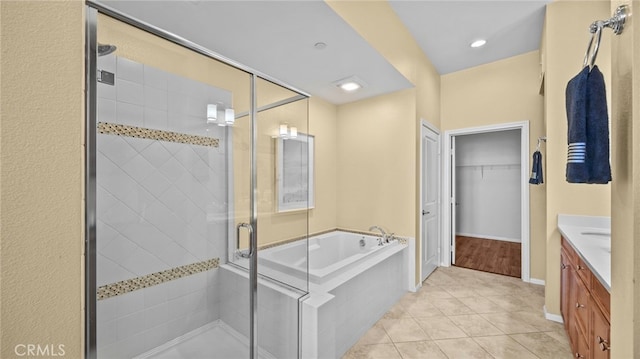 bathroom featuring tile patterned floors, vanity, and independent shower and bath