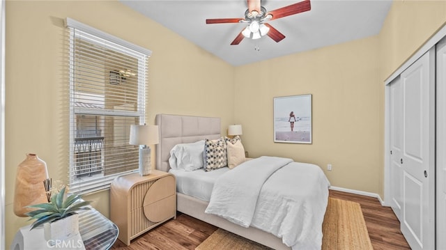 bedroom with a closet, ceiling fan, and wood-type flooring