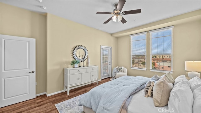 bedroom with ceiling fan and dark hardwood / wood-style flooring