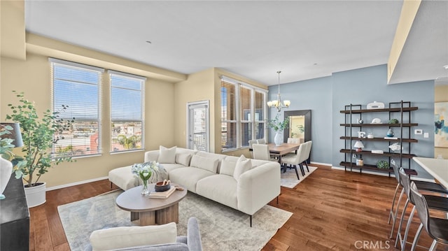 living room featuring an inviting chandelier and dark hardwood / wood-style floors