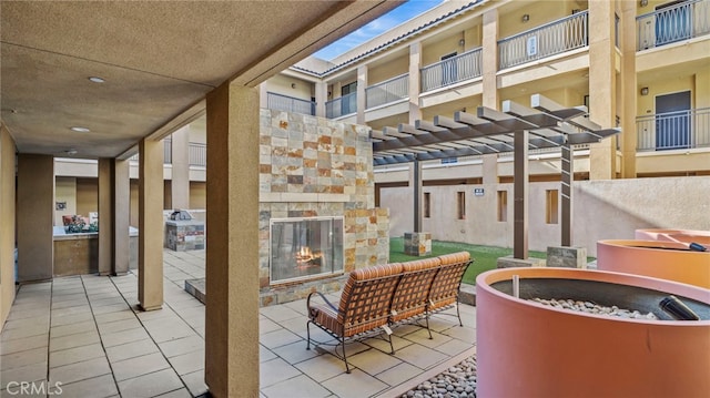 view of patio / terrace featuring an outdoor stone fireplace