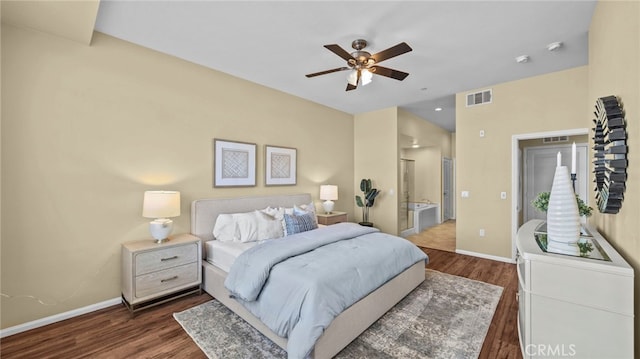 bedroom featuring dark hardwood / wood-style flooring, ceiling fan, and ensuite bath