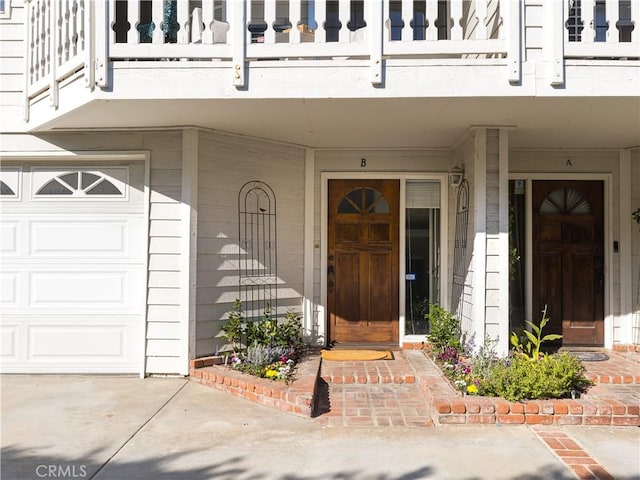 entrance to property with a garage and a balcony