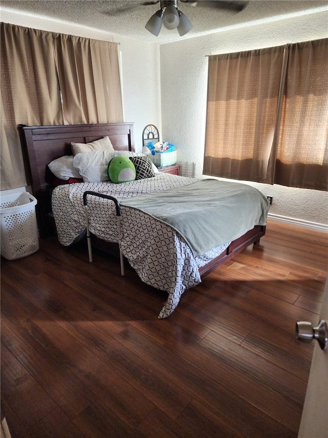 bedroom featuring dark wood-type flooring and ceiling fan