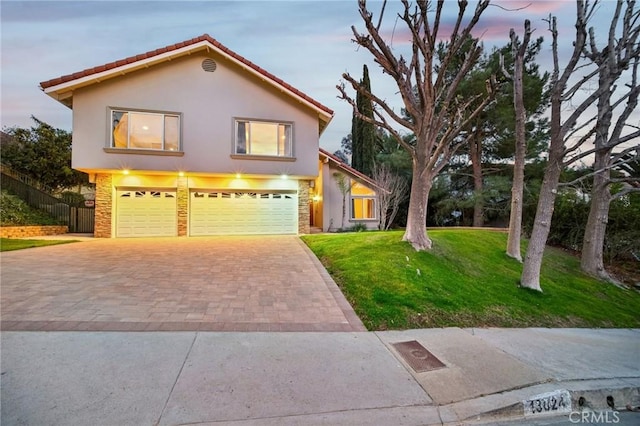 view of front facade with a garage and a lawn