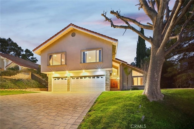 view of front facade featuring a garage and a lawn