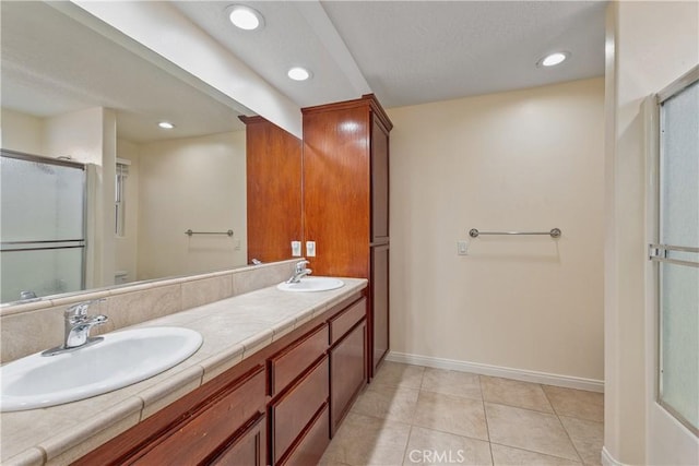 bathroom with vanity, toilet, a shower with door, and tile patterned flooring