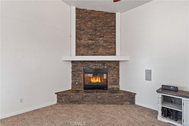 unfurnished living room featuring ceiling fan, a fireplace, and carpet flooring