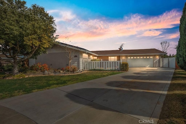 view of front facade with a garage and a yard