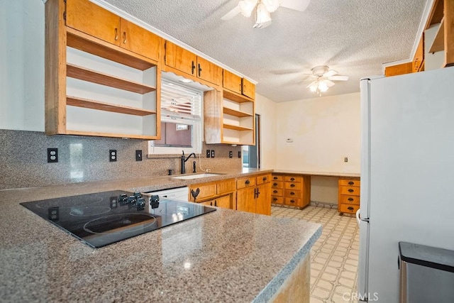 kitchen featuring sink, ceiling fan, white refrigerator, a textured ceiling, and black electric cooktop