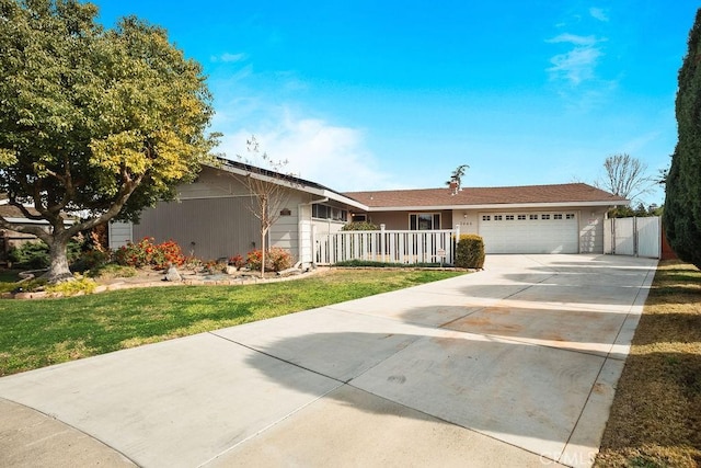 ranch-style home featuring a garage and a front lawn