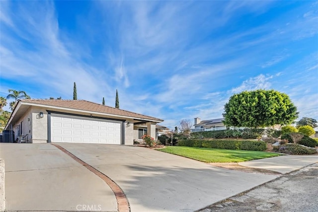 view of front of property featuring a garage and a front yard