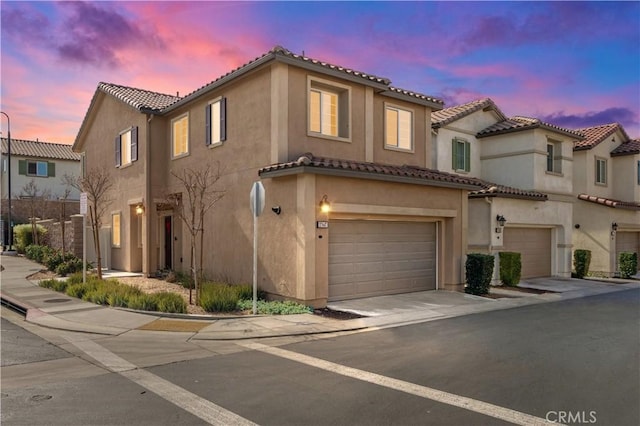 mediterranean / spanish-style house with a garage