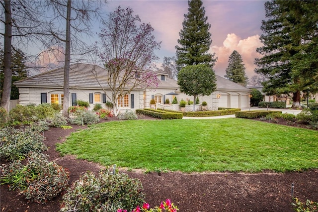 view of front facade with a garage and a yard