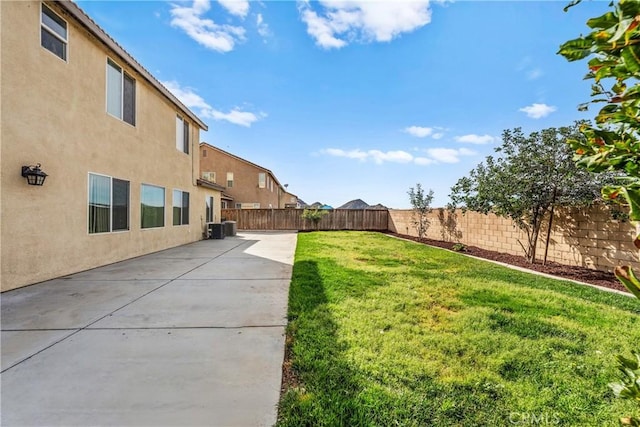 view of yard featuring a patio area, a fenced backyard, and central AC unit