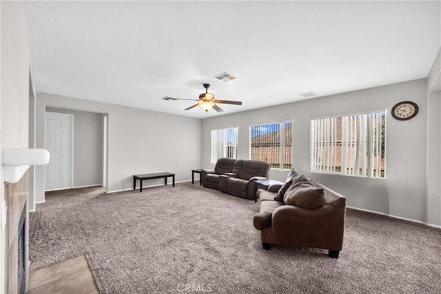 living area featuring light carpet, ceiling fan, visible vents, and baseboards