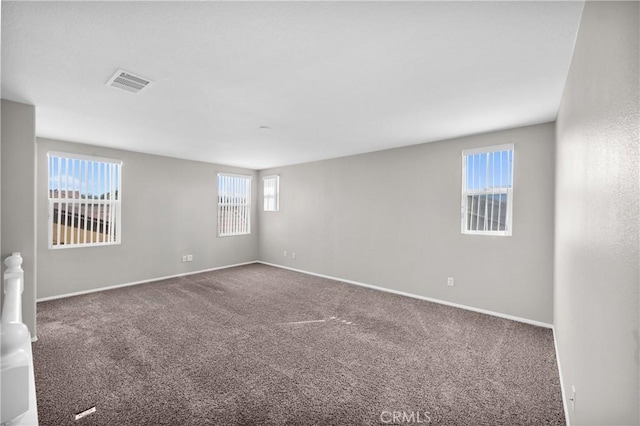 carpeted empty room with baseboards and visible vents