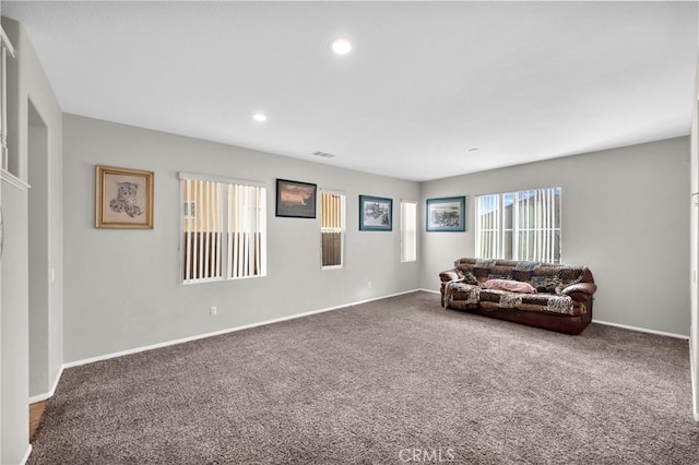 carpeted living room featuring baseboards, visible vents, and recessed lighting