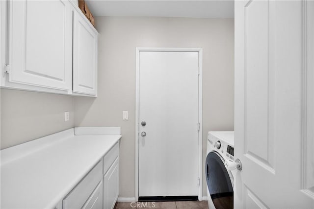 washroom with washer / clothes dryer and cabinet space