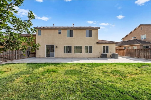 back of property with stucco siding, a fenced backyard, and a yard