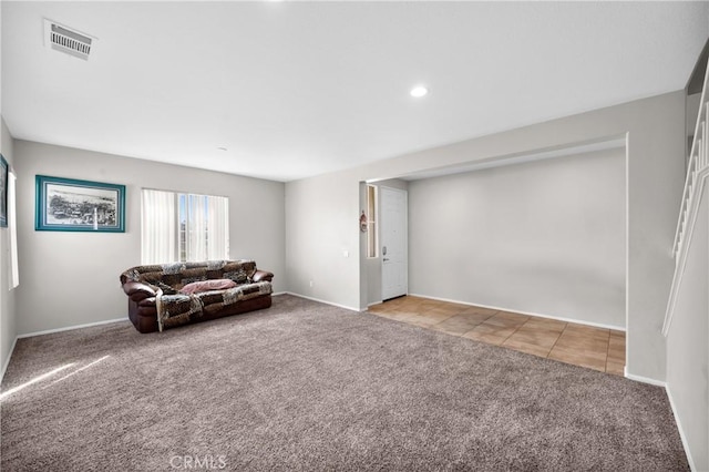 sitting room with light carpet, light tile patterned floors, baseboards, and visible vents