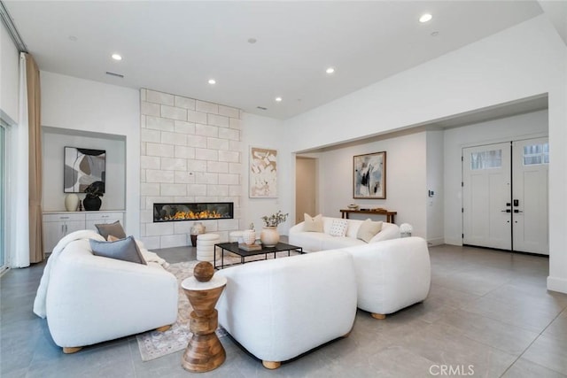 living room featuring a tile fireplace