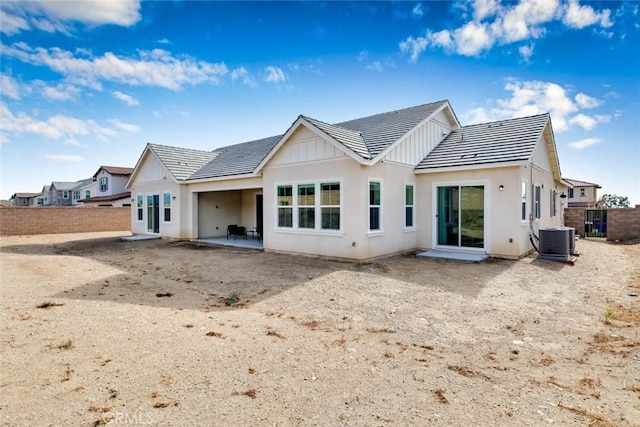 rear view of property featuring a patio area and central air condition unit