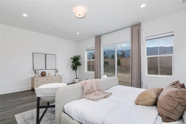 bedroom with dark hardwood / wood-style floors and access to outside