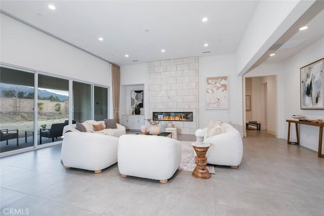 living room with a tiled fireplace