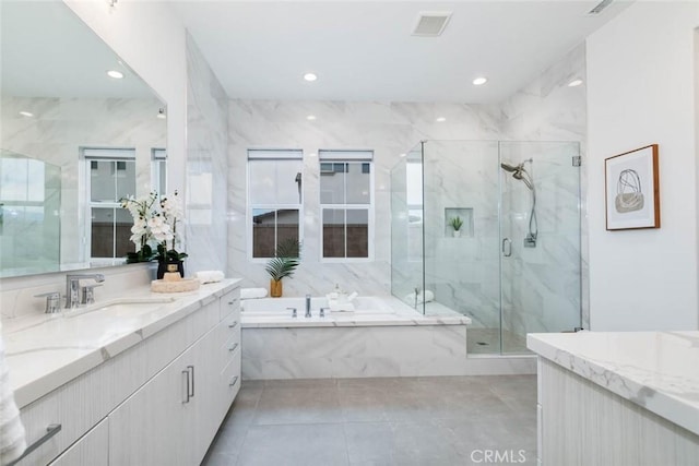 bathroom featuring vanity, separate shower and tub, and tile patterned floors