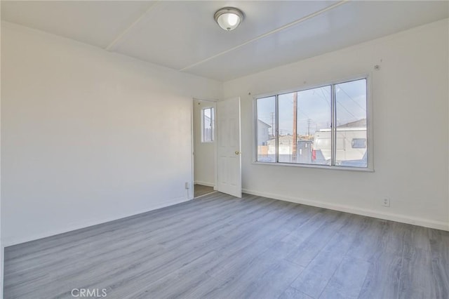 spare room featuring hardwood / wood-style floors