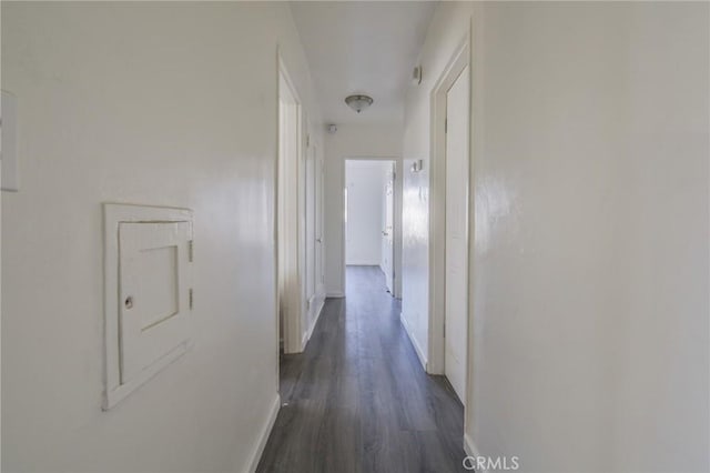 corridor with dark hardwood / wood-style flooring