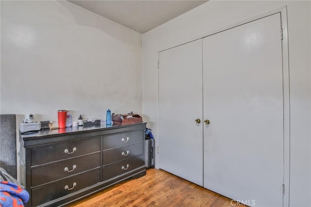 bedroom featuring light hardwood / wood-style floors and a closet