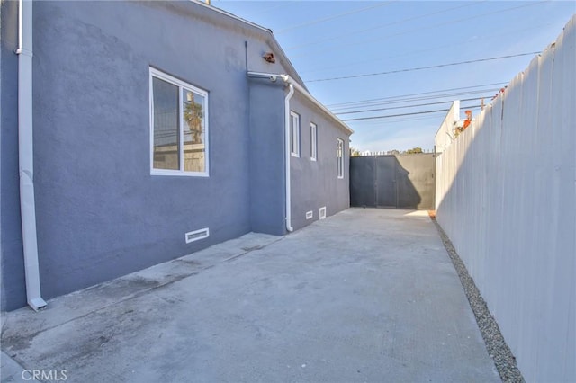 view of side of home with a patio