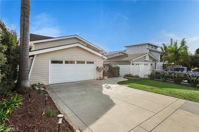 view of front of home with a garage and a front yard